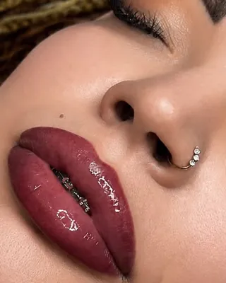 Healed lips in a deep berry shade, close up