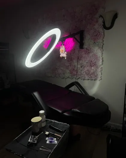The treatment room, lit by the studio pink neon